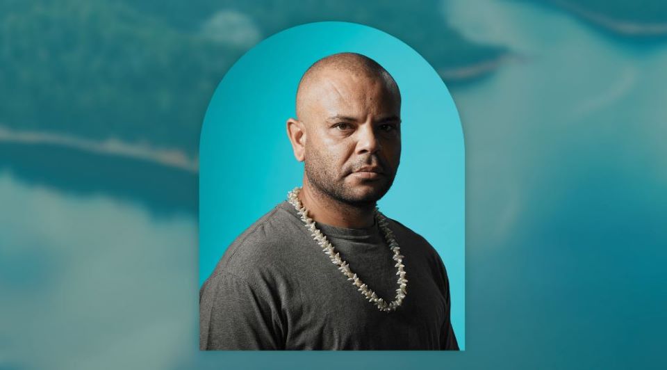 man with strong face and shell necklace