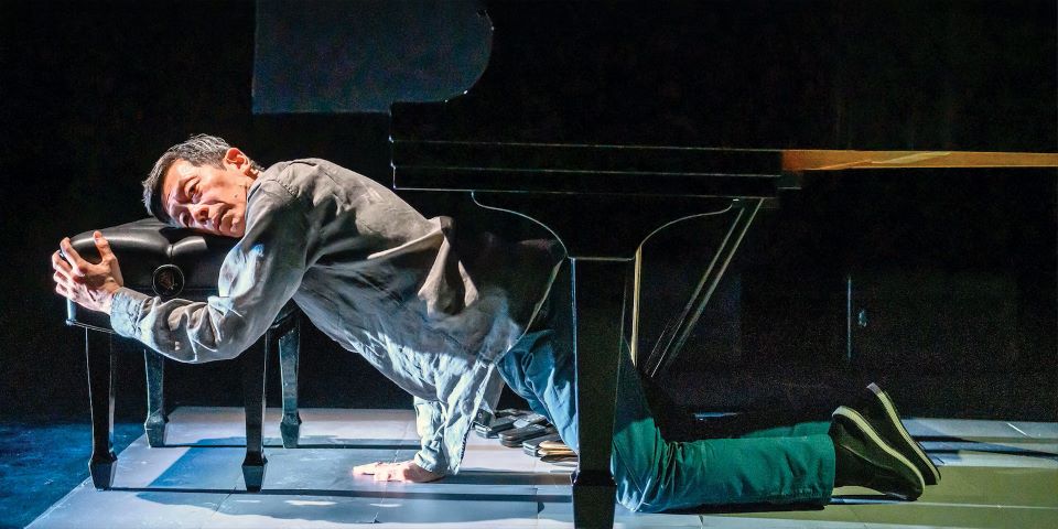man kneeling on stage