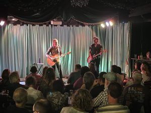Charles on stage with guitar player