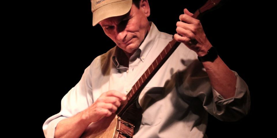 man playing banjo
