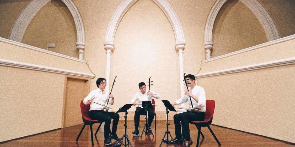 3 musicians sitting and playing