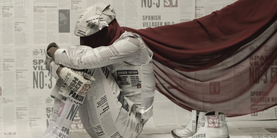 man dressed in newspapers