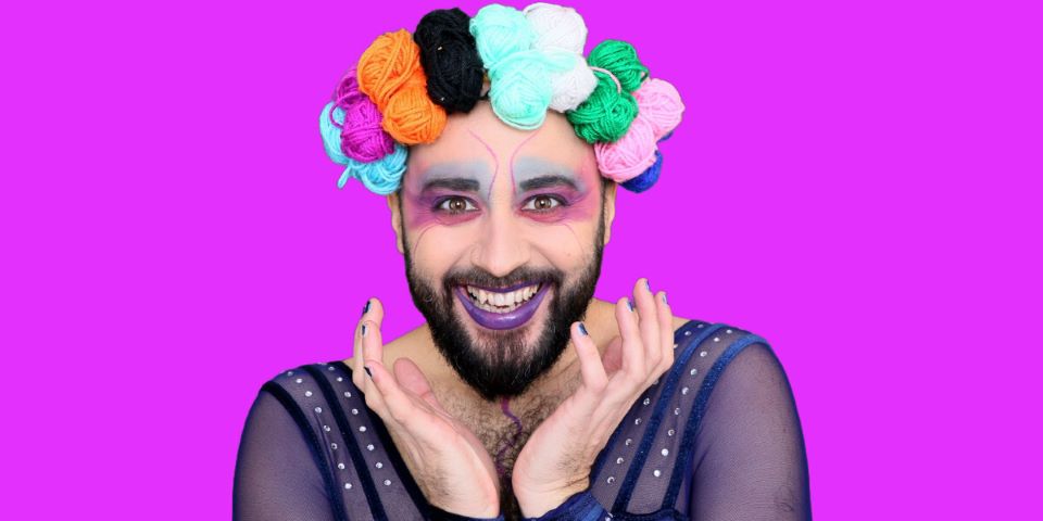 man with hat of coloured pompoms