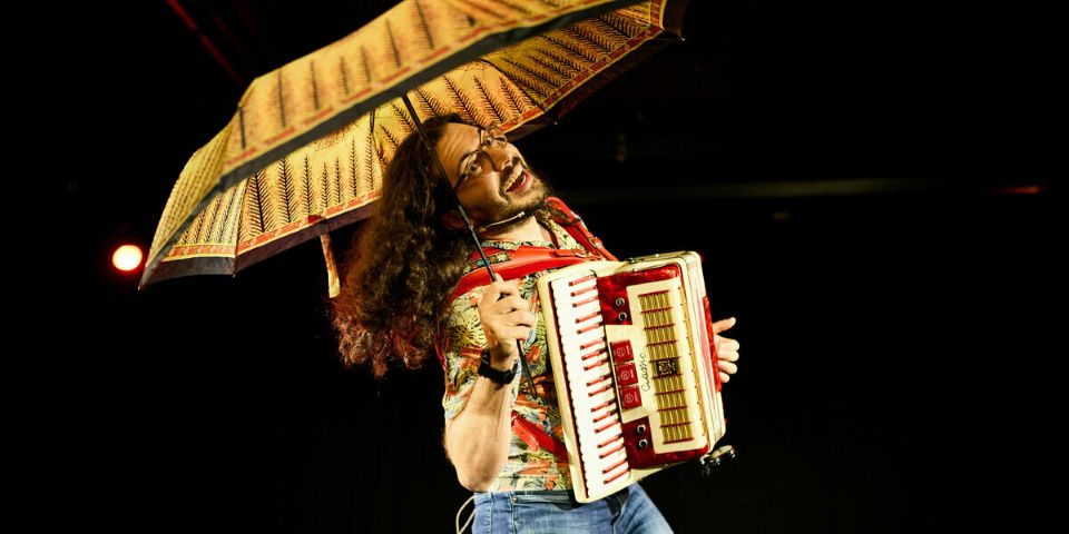 man with accordion and umbrella