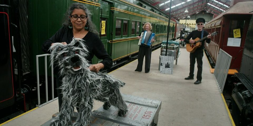 people and dog on platform
