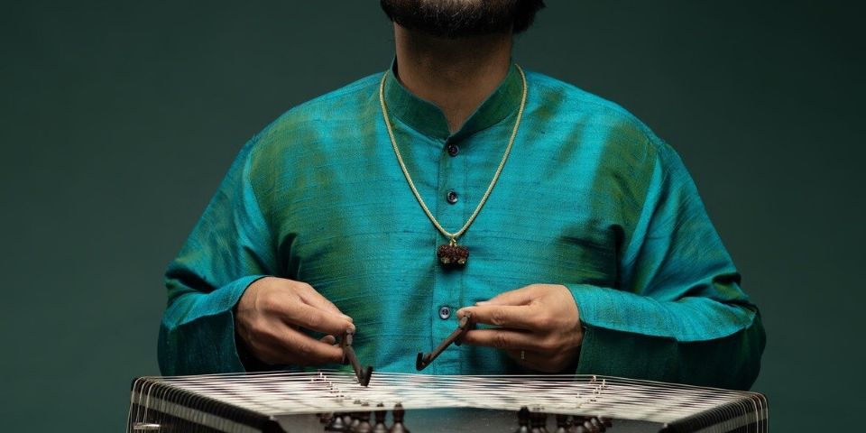 man playing santoor