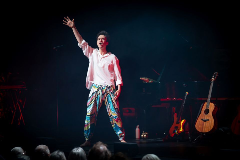 man standing and singing