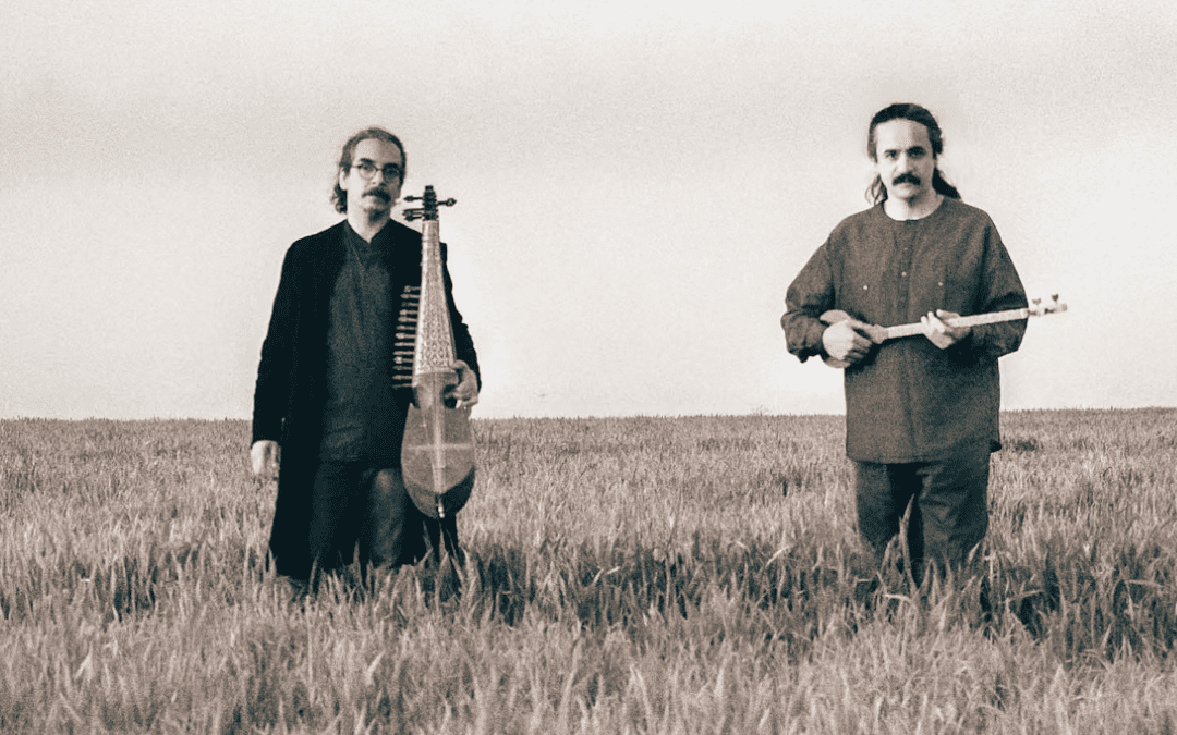 two men with instruments in field