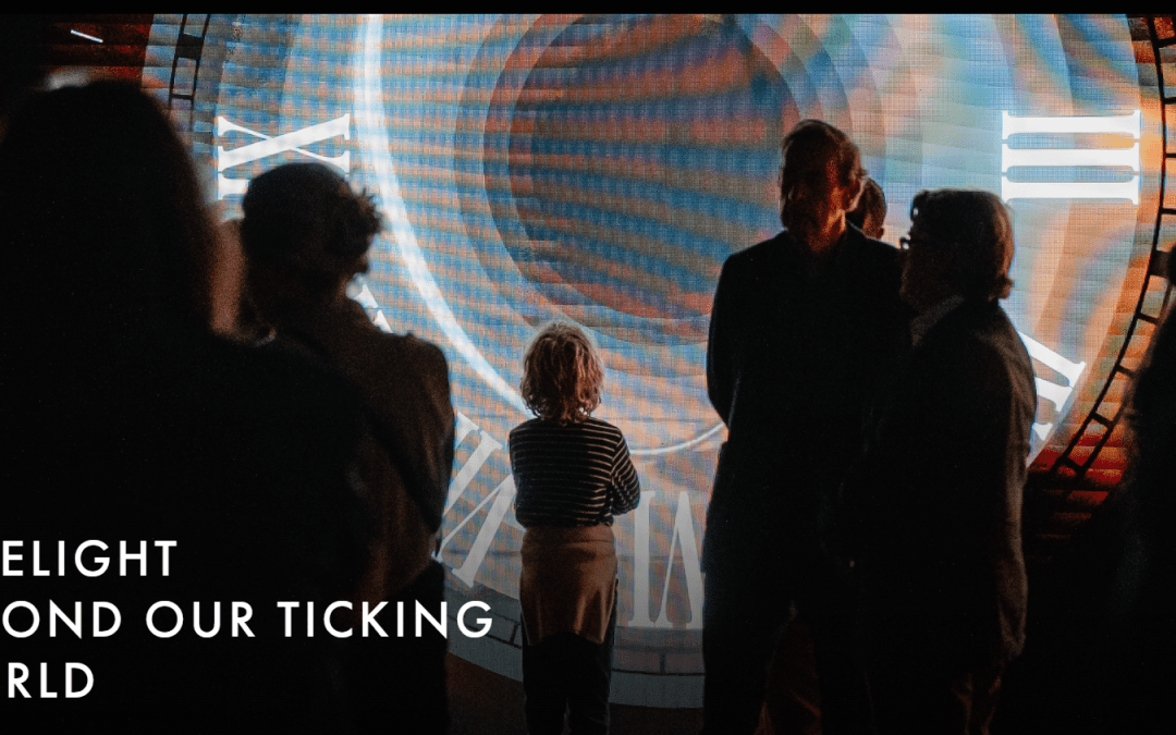 People in silhouette against projected image